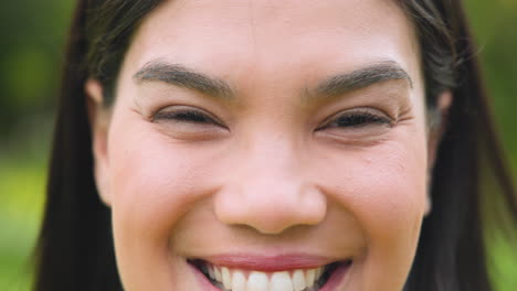 smiling woman enjoying outdoor holiday gathering with family and friends