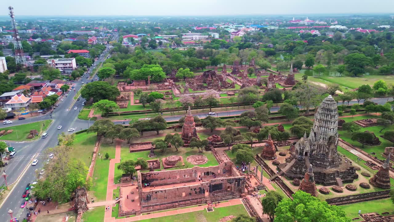 Drone orbit establishing of Ayutthaya historic temples and ancient ruins nestled in green surroundings