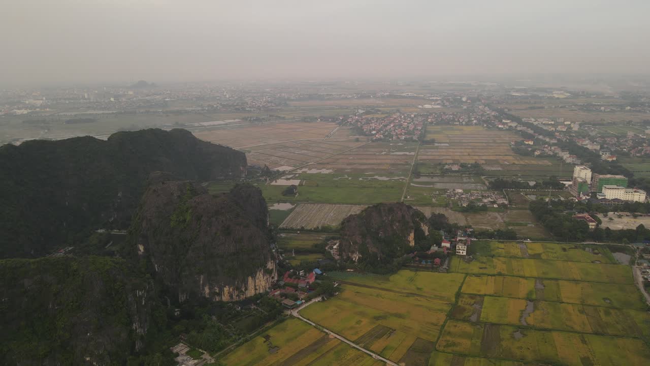 Ninh Binh limestone mountains rising up from the paddy rice field, aerial drone Vietnam