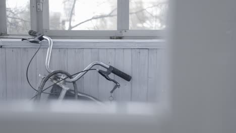 bicycle leaning against a white wall