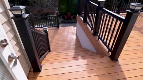 stabilized shot leading outside to back deck of luxury home