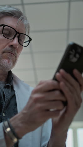 man using smartphone in a library