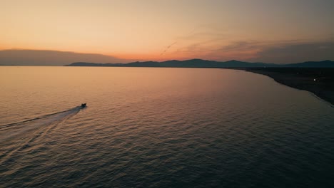 Boat-at-Maremma-National-Park-beach-with-panoramic-evening-sunset-sky-in-Tuscany,-Italy