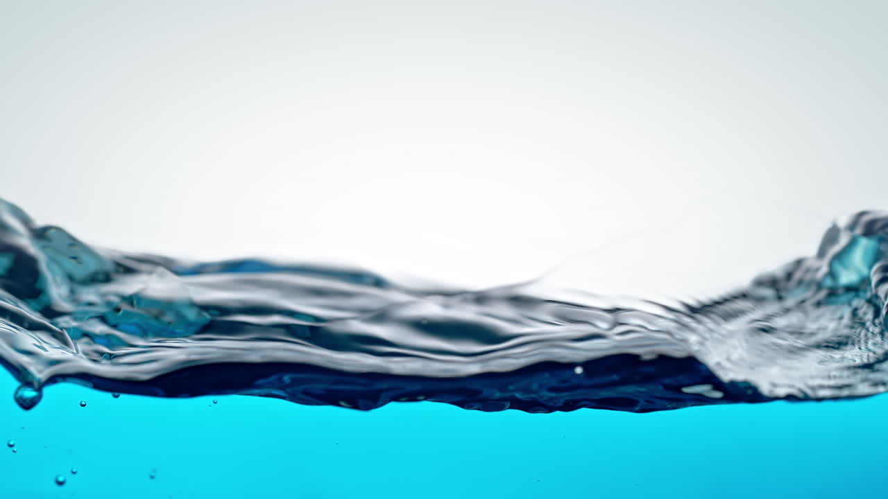 Blue Water Waves Roll And Break In Slow Motion on the White Background, Deforming Fluid Surface