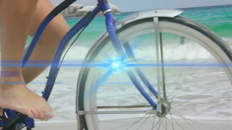 animation of blue light beam moving over bare feet of man riding bicycle on beach