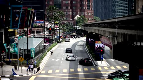 time lapse view of bukit bintang and monorail with busy traffic on daylight