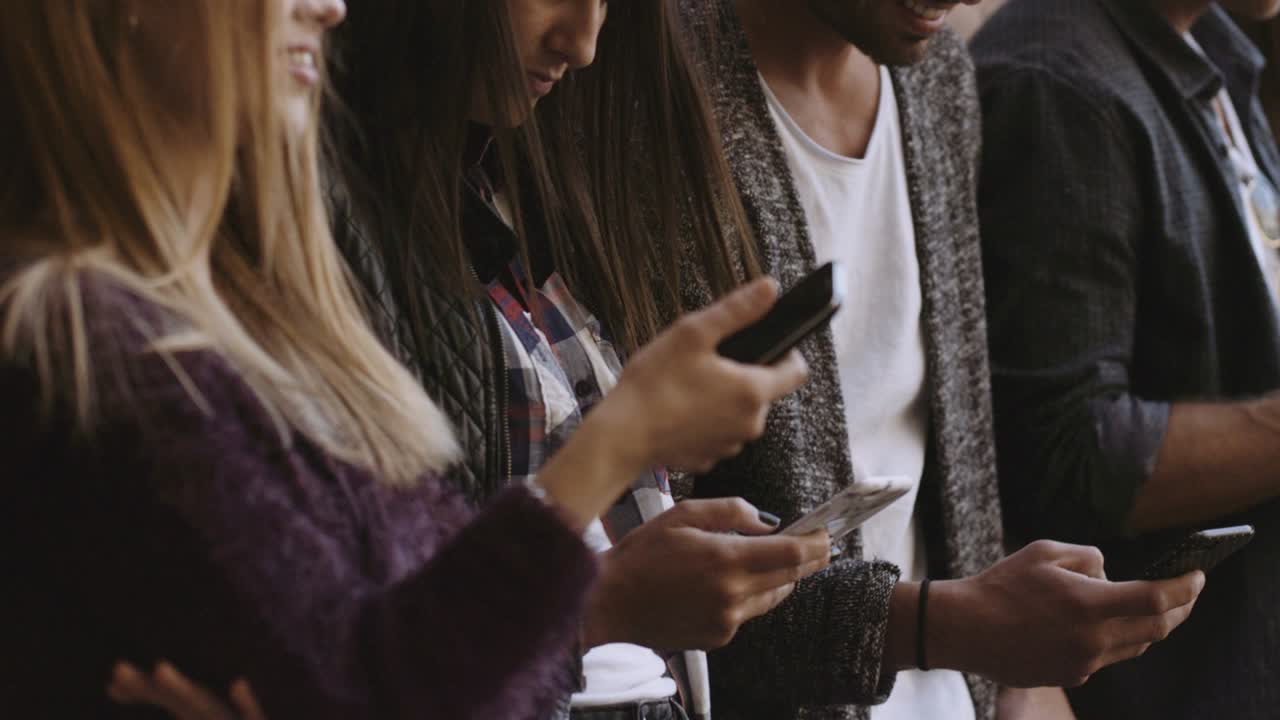 large group of friends using cellphone. shot in slow motion