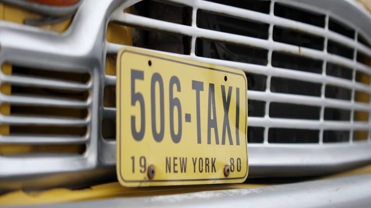 Vintage Taxi License Plate on a Yellow Car