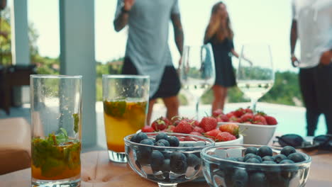 background with dj and people having fun dancing at villa with sea view near pool daytime