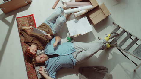 Couple-Lying-on-Floor-and-Talking-about-Home-Renovation-Plans