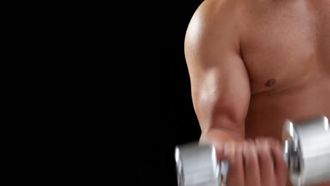 bodybuilder lifting heavy dumbbell