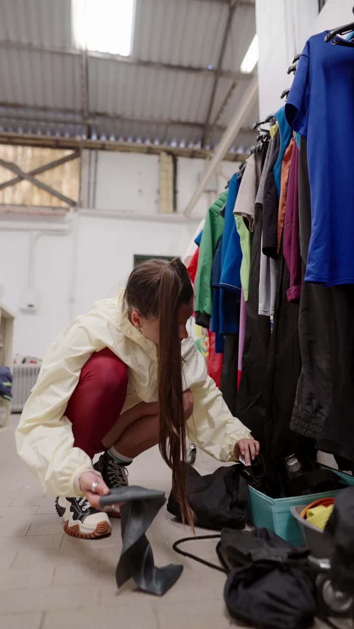 Woman organizing clothes and equipment in a storage room