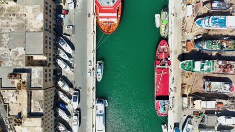 Aerial-Drone-shot-rising-over-ships-in-a-boat-yard-at-top-down-view