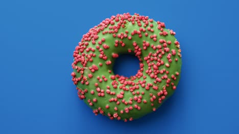 tasty doughnut covered by green glaze and pink sprinkle rotate isolated. shot with red camera in 4k