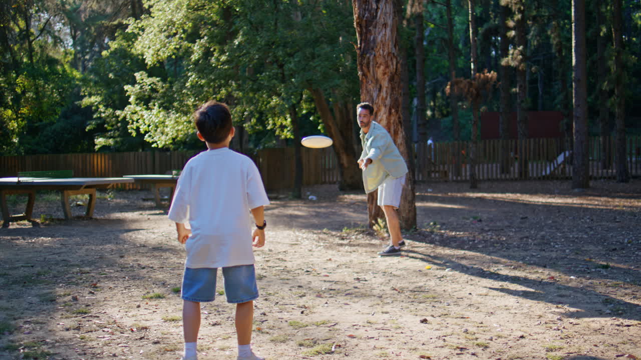 Happy family playing frisbee summer park. Parent child throwing each other disc