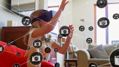 Animation-of-network-of-connections-with-icons-over-girl-wearing-vr-headset