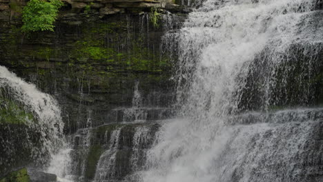 slow motion shot of waterfall hitting rocks at upper balls falls in ontario with mist and flow