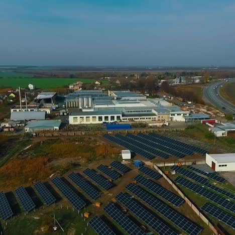 aerial view on solar plant. photovoltaic power panels in front in field. renewable energy, technology, electricity, service, green power. video from above