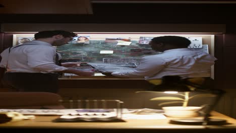 police detectives reviewing evidence at a crime scene