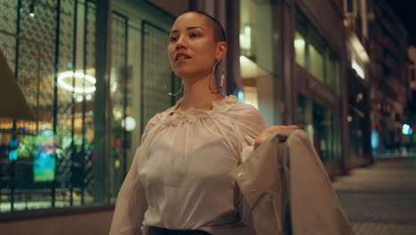 woman walking at night in city