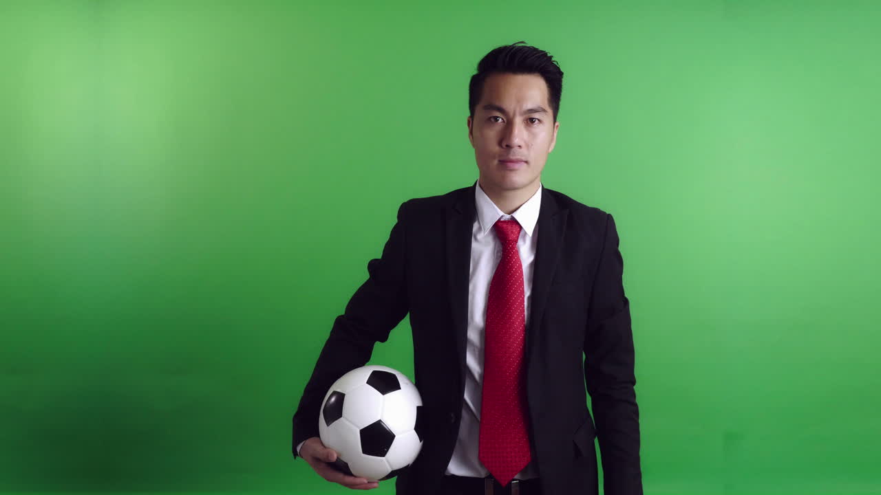 Asian Soccer Manager Holding A Soccer Ball With Green Screen, Video In 4K