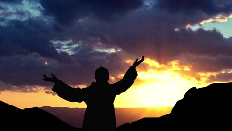 man is praying. the holy month of ramadan. morning prayer and the beginning of fasting. silhouette at sunrise.