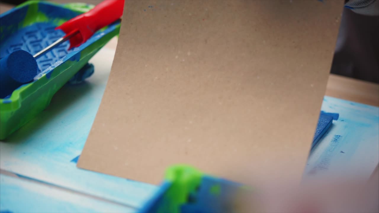 Child painting with various tools