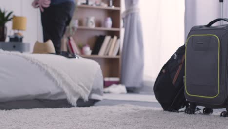 man at home picking up luggage and leaving for summer holiday