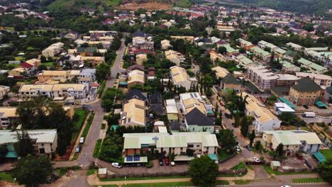 aerial view of a beautiful urban neighborhood in abuja, nigeria. the drone slowly flies towards the large and expensive houses in the residential area