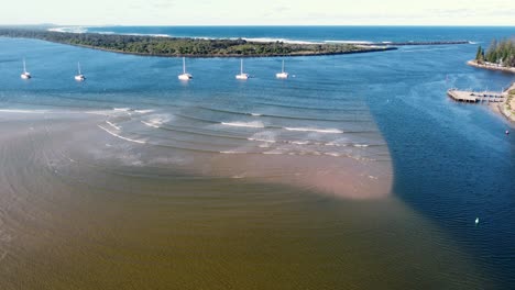 Aerial-drone-scenic-landscape-shot-of-Hastings-River-channel-sand-bank-inlet-with-yachts-Pacific-Ocean-Mid-North-Coast-NSW-Australia-4K