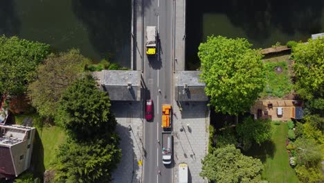 Highway-maintenance-and-repair-vehicles-are-set-up-ready-to-work-on-an-old-bridge-coned-off-for-traffic-to-flow-one-way