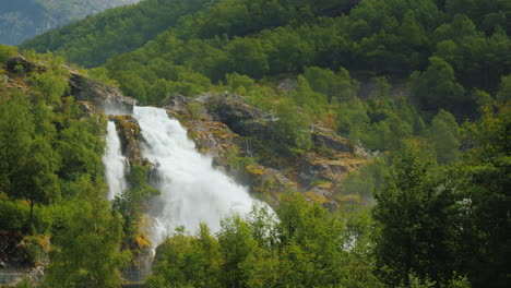 waters of the waterfall at the bottom of the bridge in the distance meltwater from the glaciers in t