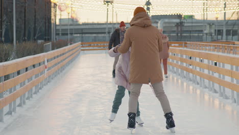 family ice skating lesson at the park