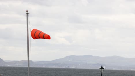 windsock swaying in the wind, scenic background