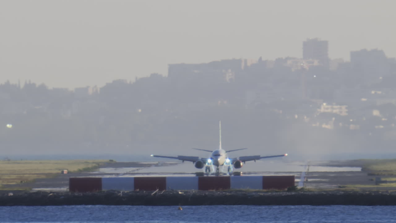 Distant view of airplanes landing at the Nice Cote d'Azur Airport in daylight