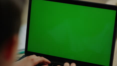 Boy-typing-on-computer-at-home.-Schoolboy-looking-laptop-screen-inside.