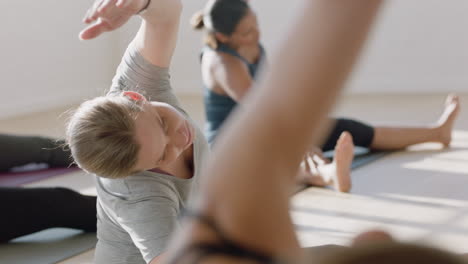 young pregnant caucasian woman in yoga class practicing stretching exercises enjoying group fitness workout at sunrise healthy lifestyle commitment