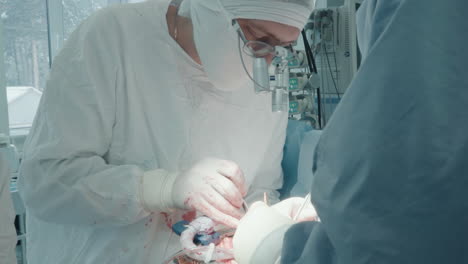 surgical team performs surgery in clinic. skilled surgeon with assistant operates chest of patient placing harvested vessels onto coronary artery