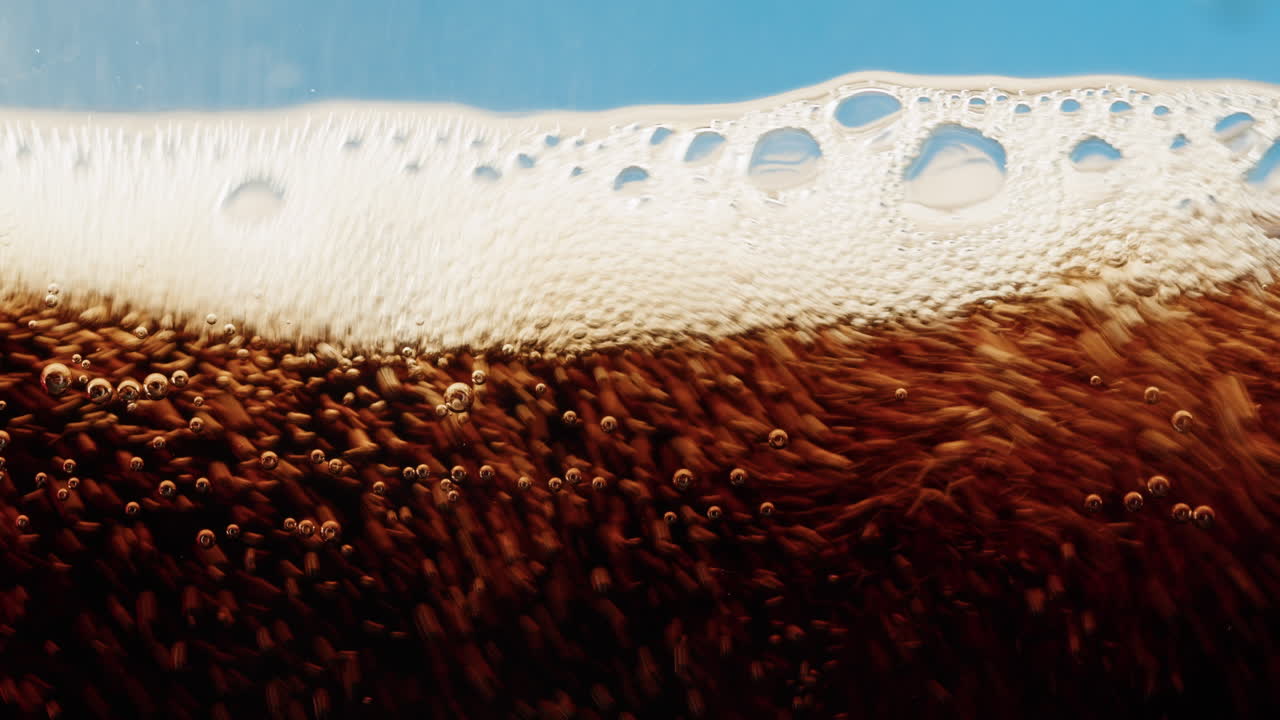 Close-up of soda with bubbles and foam