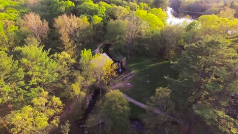 4k circling aerial view of classic new england stone mill and wedding chapel