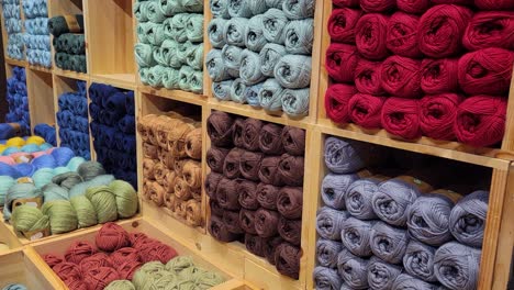 wide tilt down of colored yarn in a craft shop