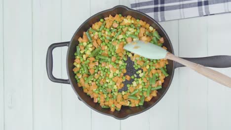 top down of stir fried food organic vegetable cocked in a pan for healthy vegetarian vegan diet