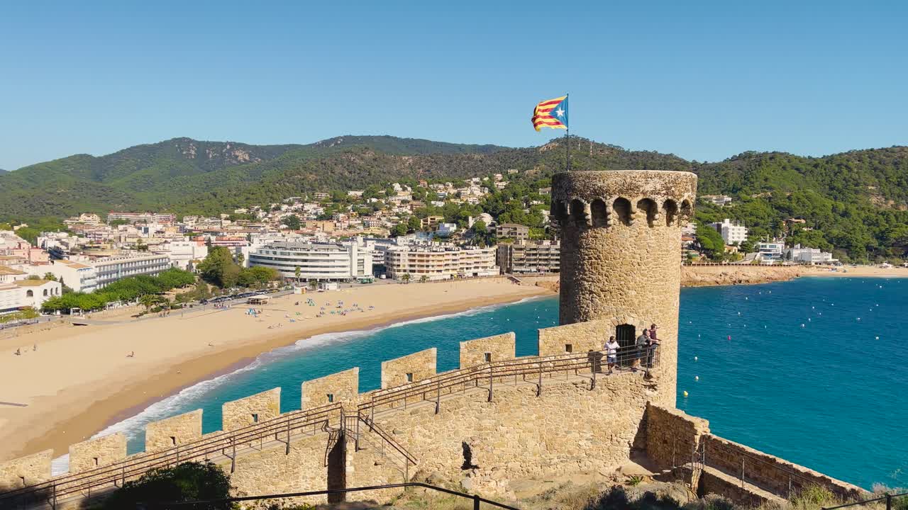bahía de tossa de mar vista desde el castillo hasta la playa con arena gruesa y agua de mar azul turquesa antiguo pueblo pesquero medieval amurallado mar mediterráneo