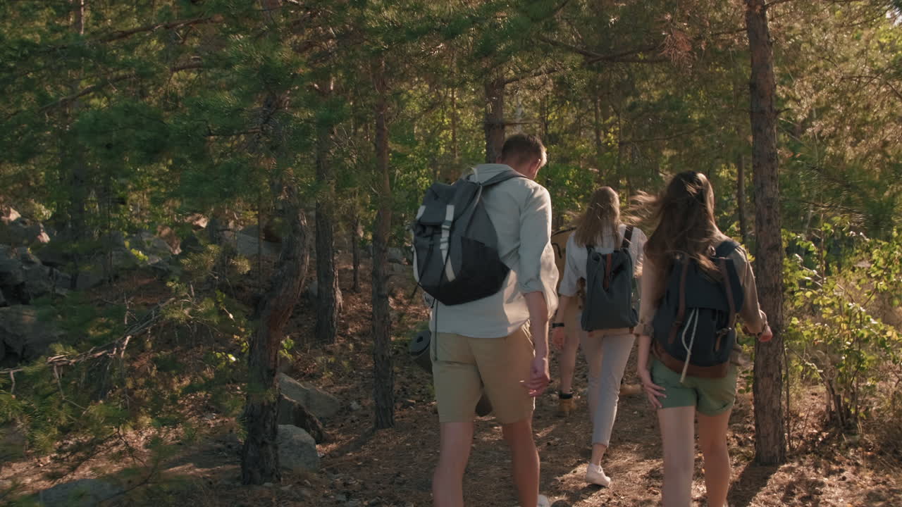 Young People Hiking in Woods