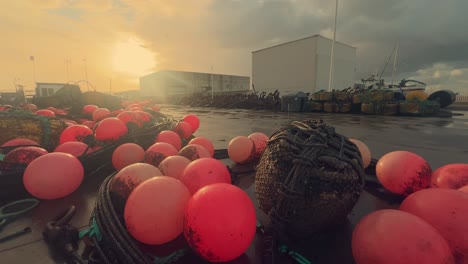 cheerful red buoys adorn the quays of a picturesque spanish fishing village, securely fastened to the coastal jetty, offering a peek into the allure of this snug harbor and its fishing populace