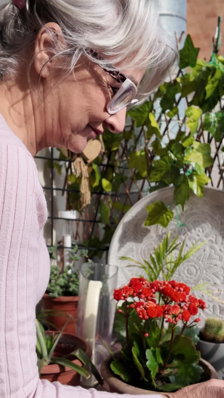 Senior woman tending to her balcony garden