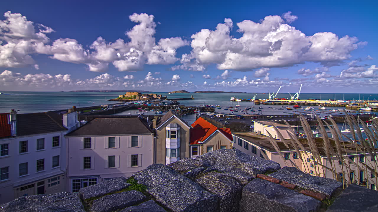 Panning time lapse shot over a busy harbor on the sea of the Channel Island of Guernsey