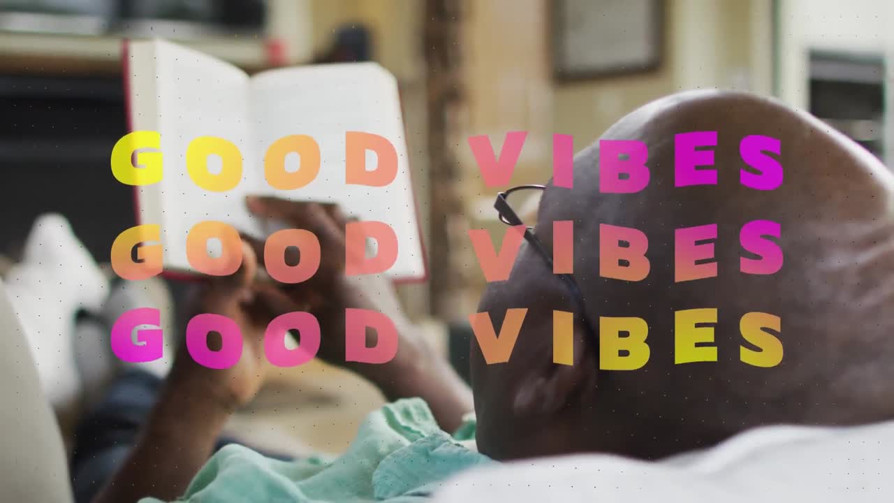 Animation of good vibes text over senior african american man reading