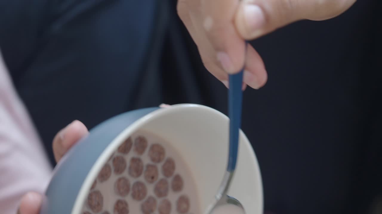 Person Eating Chocolate Cereal