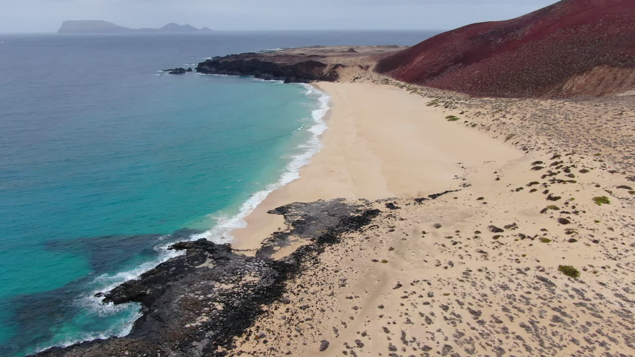 Scenic Beach with Turquoise Water and Volcanic Rock